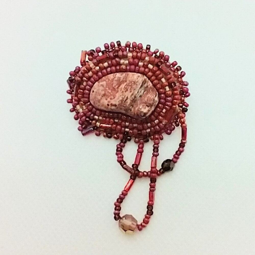 Beaded brooch Handmade Reddish color stone center Suede cloth backing